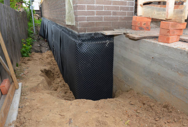 Happy homeowners after waterproofing job in Genesee
